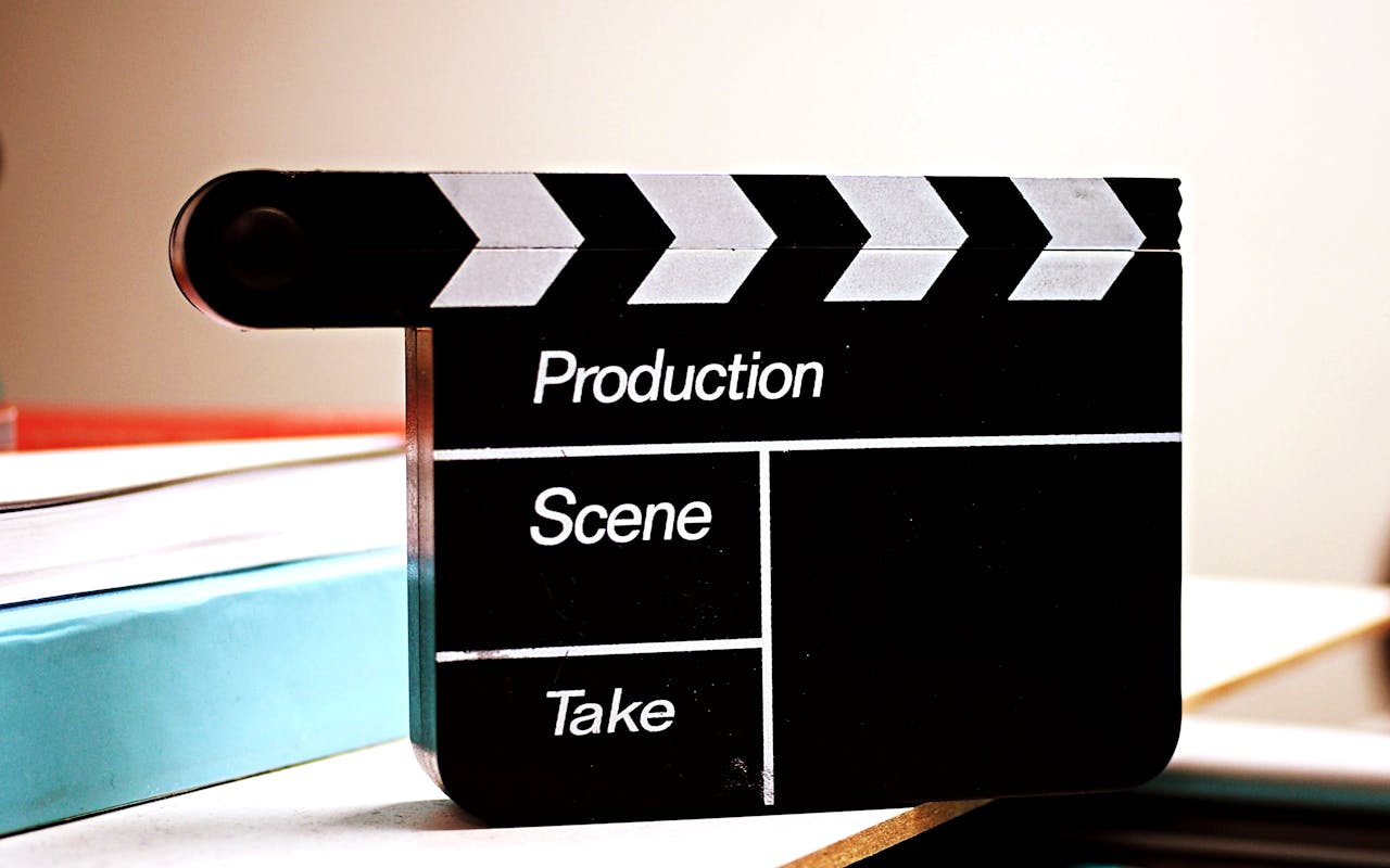 about-03 Close-up of a film clapperboard on a desk, ideal for media and production themes.